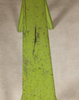 Close-up of curved bench seat with distressed green paint