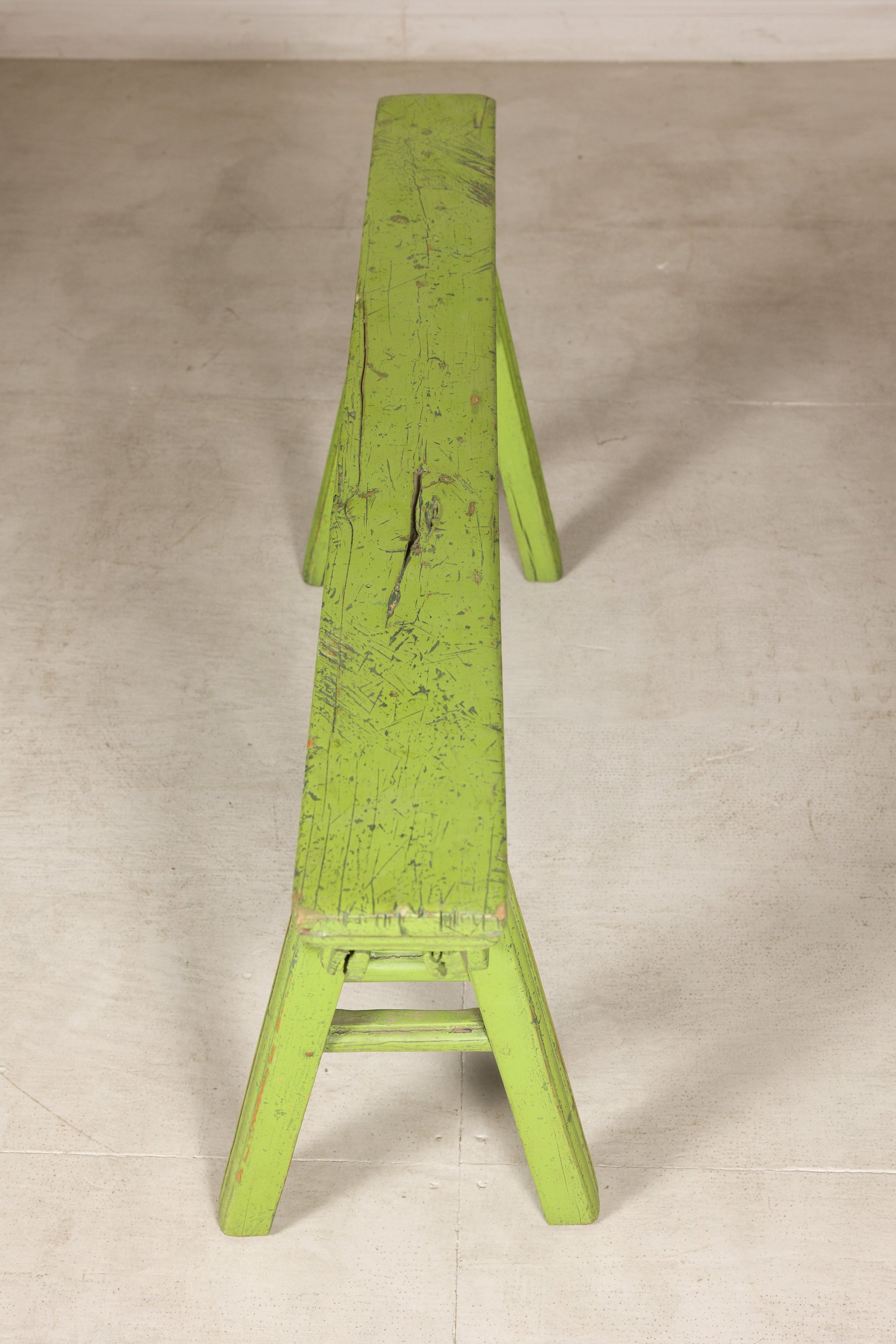 Narrow end view of green bench and seat top
