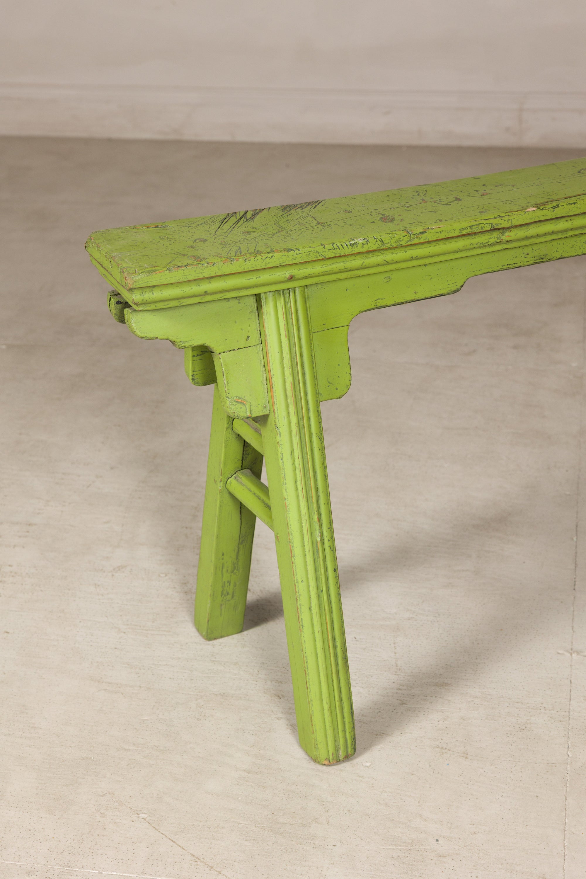 Close-up of green bench end and curved seat