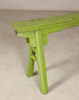 Close-up of green bench end and curved seat