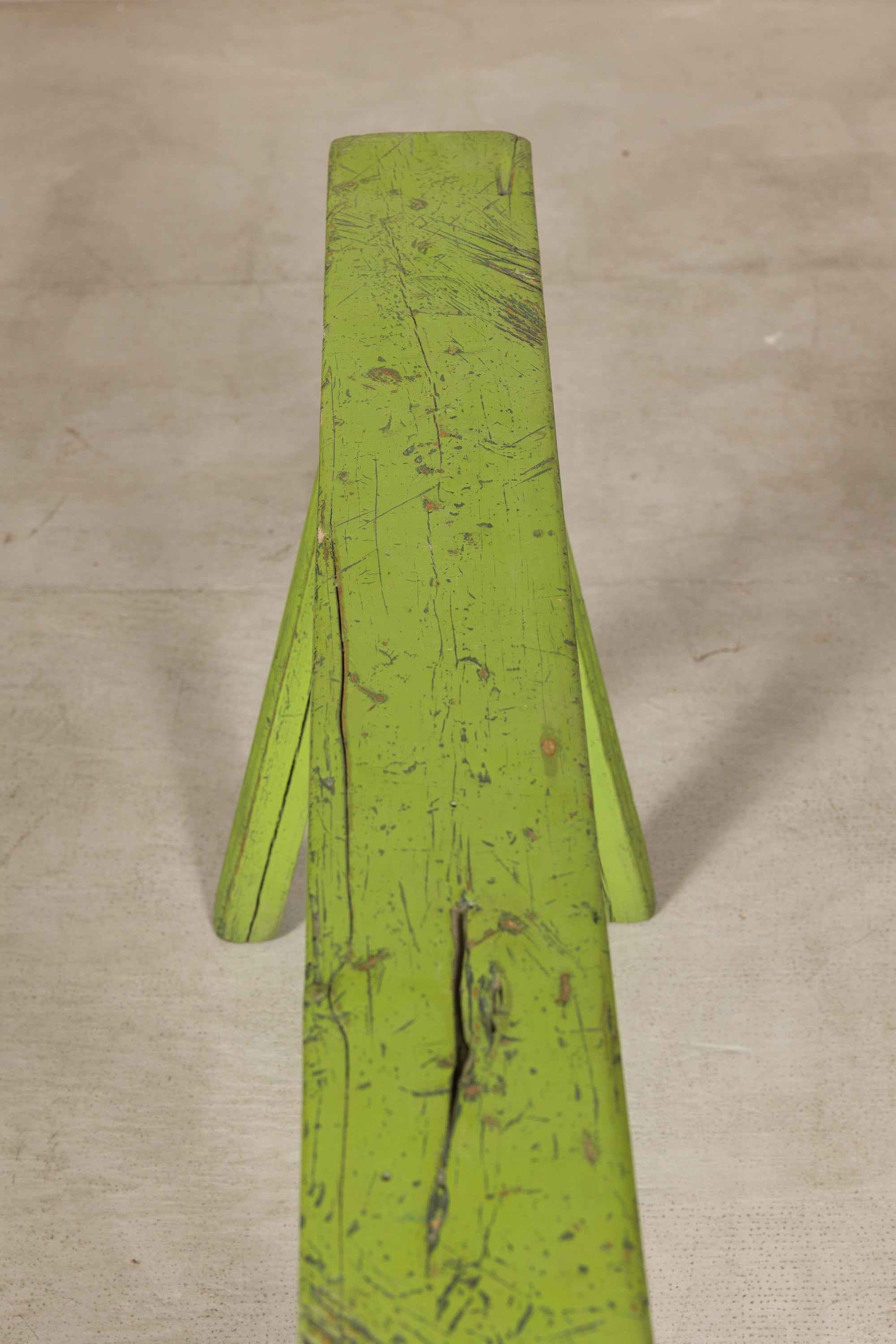 Top view of green bench seat showing worn paint