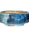 Close-up of blue and white glazed ceramic Shigaraki style low planter with wide opening.