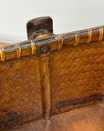 Close-up of the Woven Rectangular Picnic Basket with Handle & Hinged Lid, featuring a reinforced wooden rim and vertical support post with metal fastener. The aged wood highlights Southeast Asian craftsmanship.