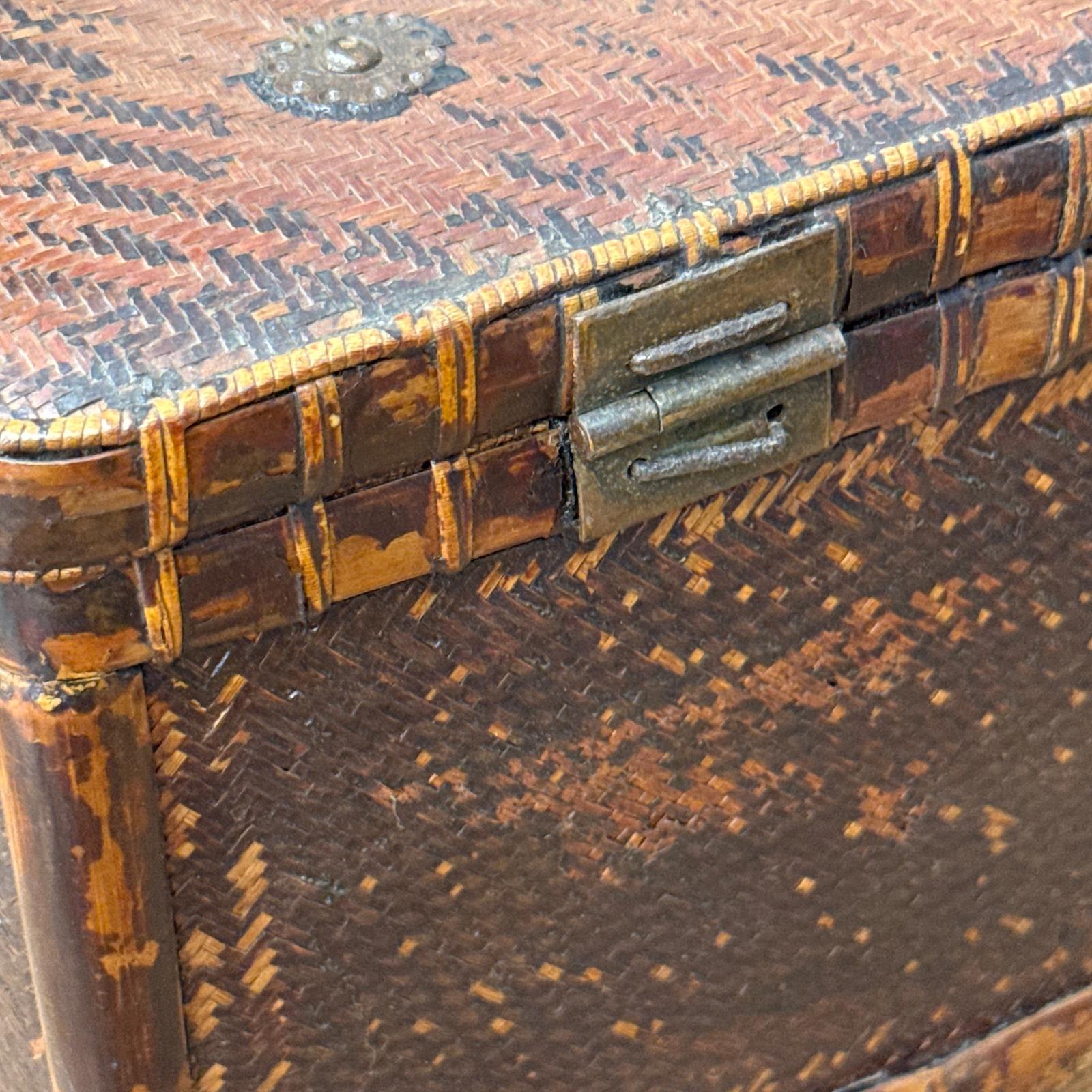 Close-up of the Woven Rectangular Picnic Basket with Handle &amp; Hinged Lid, featuring detailed rattan texture, metal hinge and clasp, and worn edges that reflect its Southeast Asian craftsmanship and vintage charm.