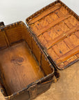 The Woven Rectangular Picnic Basket with Handle & Hinged Lid is open to reveal its wooden interior and underside of the lid, highlighting refined Southeast Asian craftsmanship as it rests on a wooden surface.
