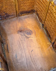 A close-up shows the inside of the Woven Rectangular Picnic Basket with Handle & Hinged Lid, featuring a wooden base with visible grain and warm brown bamboo sides that highlight Southeast Asian craftsmanship.