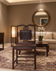 Living room with beige sofa, wooden chair, and decorative elements.