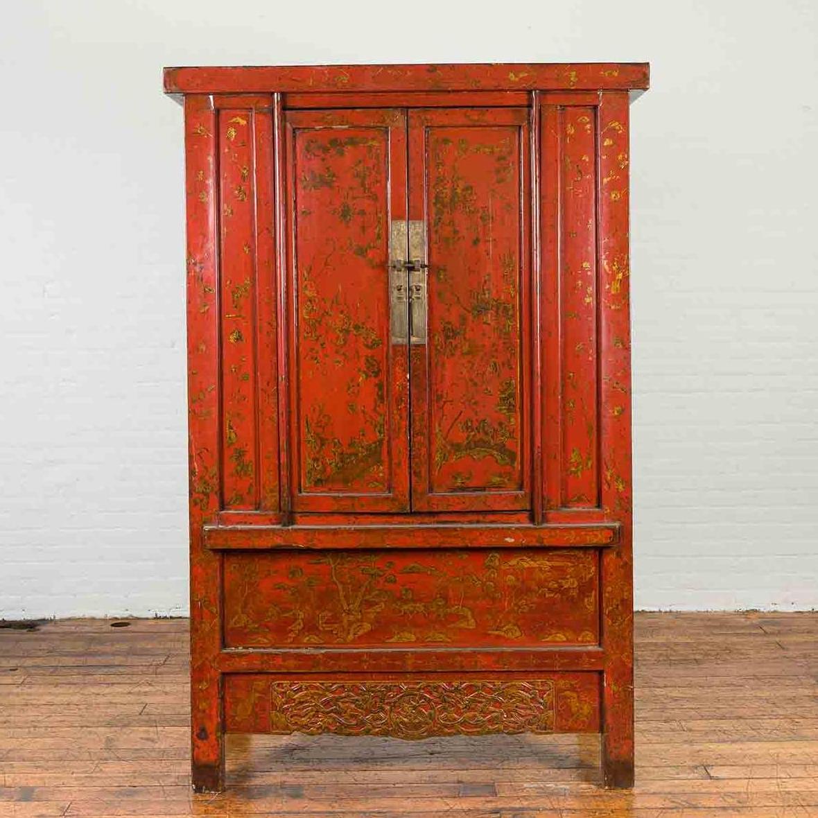 Antique red lacquer wood cabinet with gold floral designs and double doors, on wooden floor.