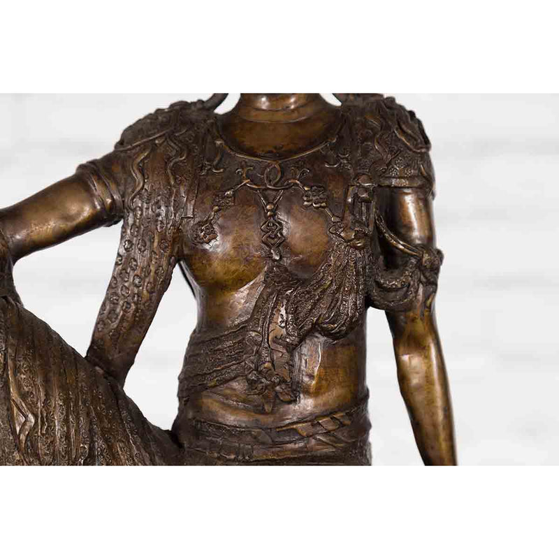 Vintage Bronze Statuette Depicting Quan Yin Seated on a Rocky Formation