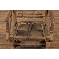 Rustic 19th Century Indian Rocking Chair with Metal Accents and Turned Supports
