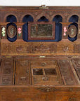 Brown wooden vintage Indian wedding chest with brass foliage décor, multiple compartments, open on wooden floor.