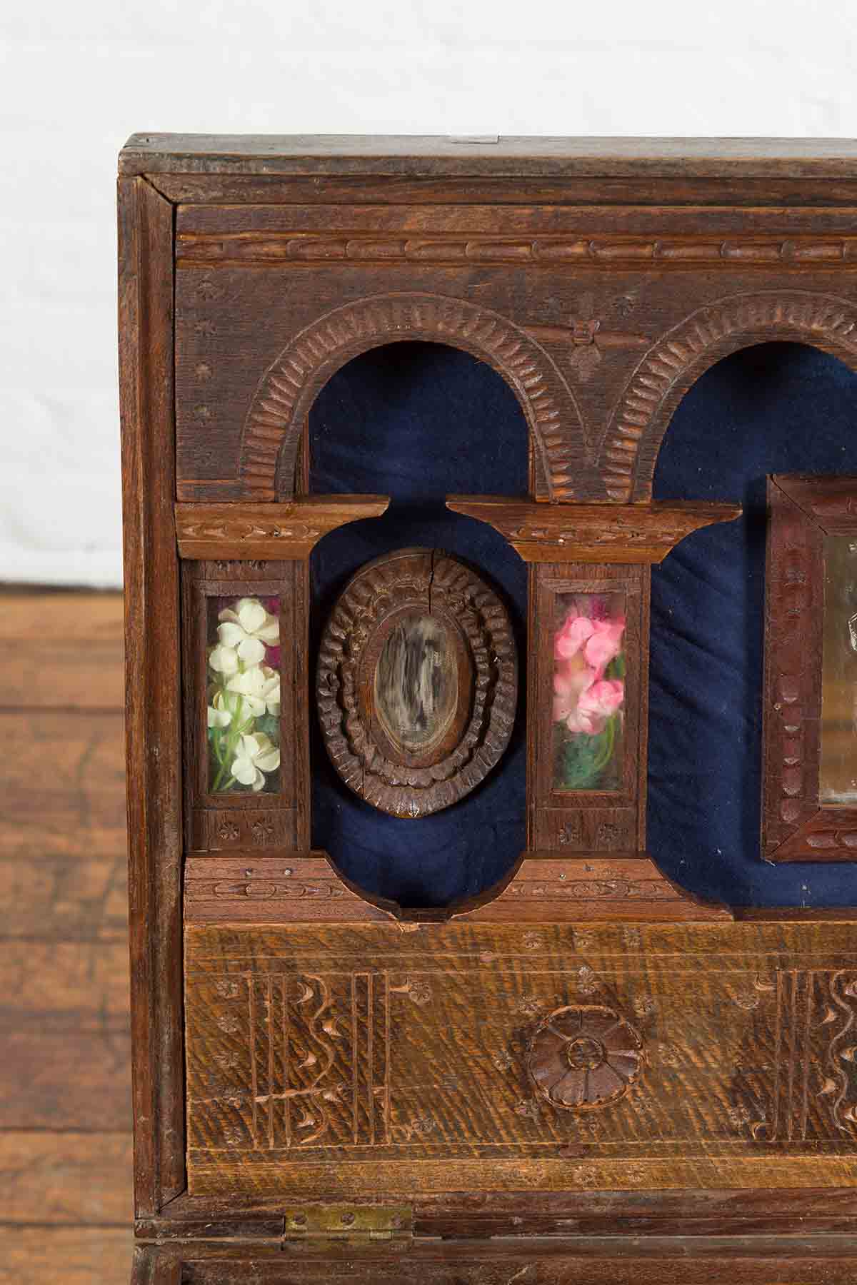 Close-up of brown wooden Indian vintage wedding chest with brass foliage décor and multiple storage compartments.