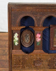 Close-up of brown wooden Indian vintage wedding chest with brass foliage décor and multiple storage compartments.