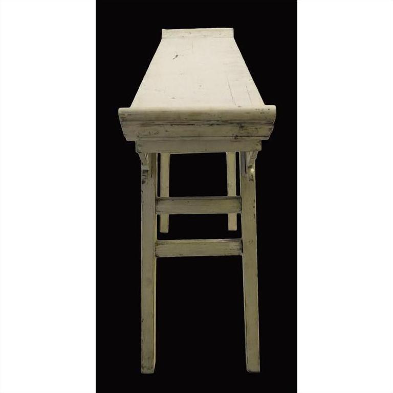 Front-facing altar table made of aged white wood with worn paint, photographed against a black background.