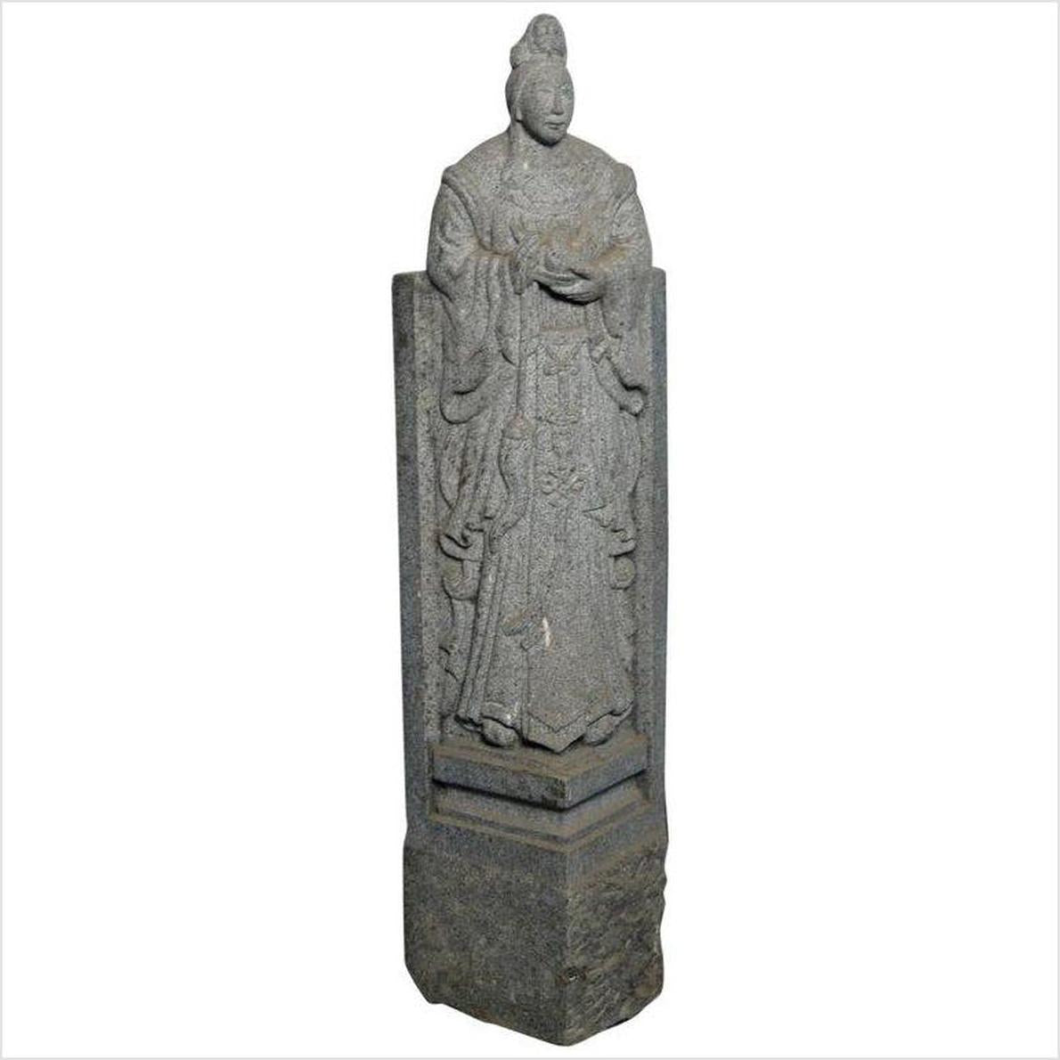 Gray stone hand-carved Chinese guardian sculpture of robed figure with ornate headdress on pedestal.
