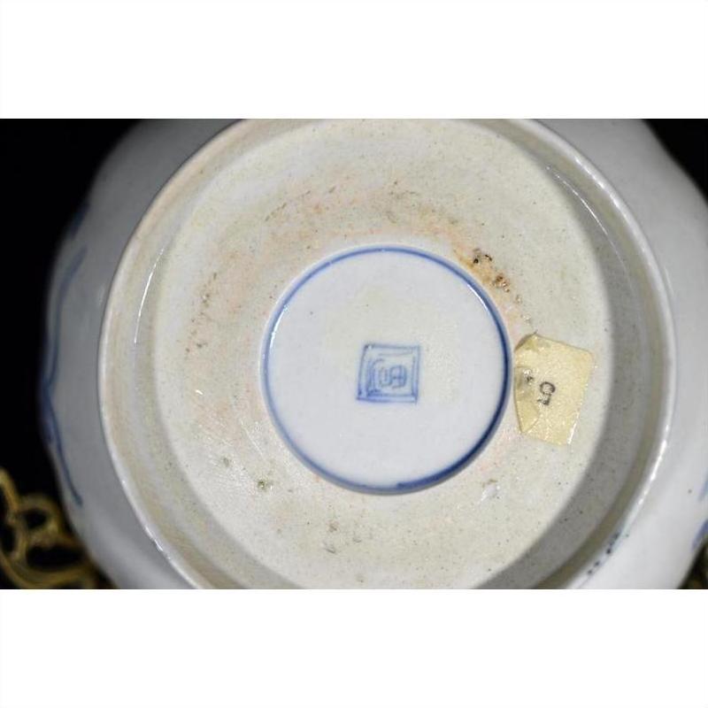 White porcelain bowl with hand painted Asian design, close-up view.