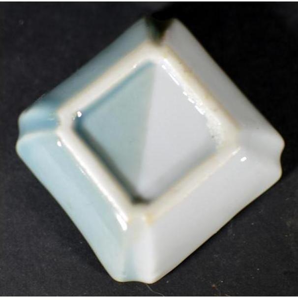 Blue and white porcelain square dish with ombré glaze and raised edges, antique Asian hand-painted design, close-up.