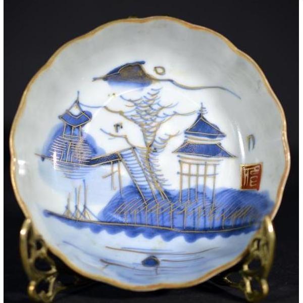 White porcelain plate with hand painted Pagoda Island scene, red seal mark, on decorative stand.