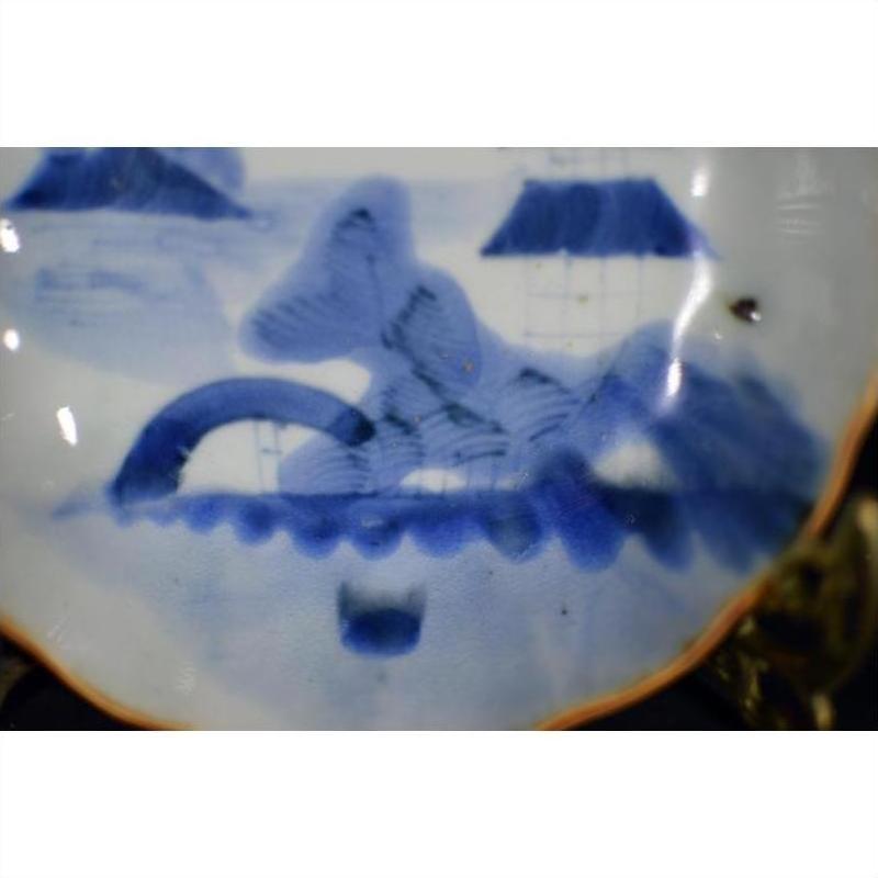 White porcelain plate with Misty Peaks and Arched Bridge design, abstract scene, scalloped rim, close-up view.