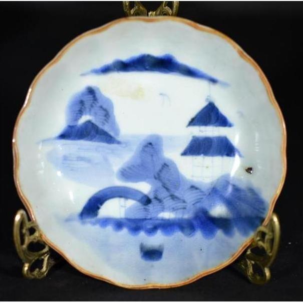 White porcelain plate, hand-painted with "Misty Peaks, Arched Bridge" design, displayed on brass stand.