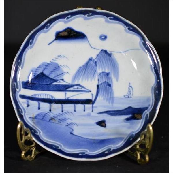 White porcelain plate with hand-painted River Pavilion, willow trees, mountains, and sailboat motifs, close-up view.