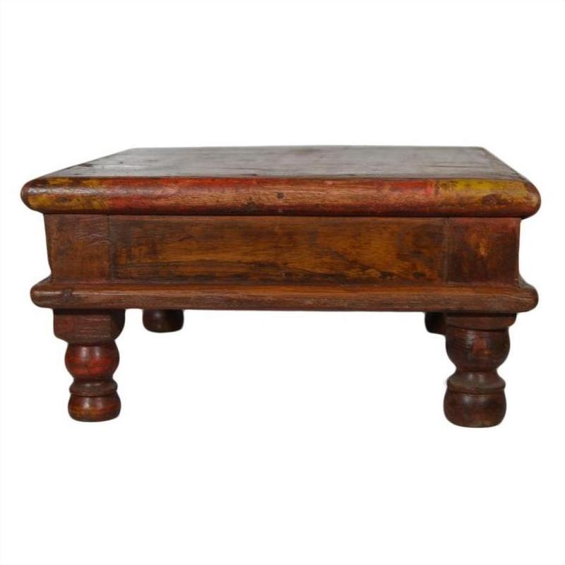 Rustic brown wooden Asian prayer table or coffee table with thick legs and rectangular top, close-up view.