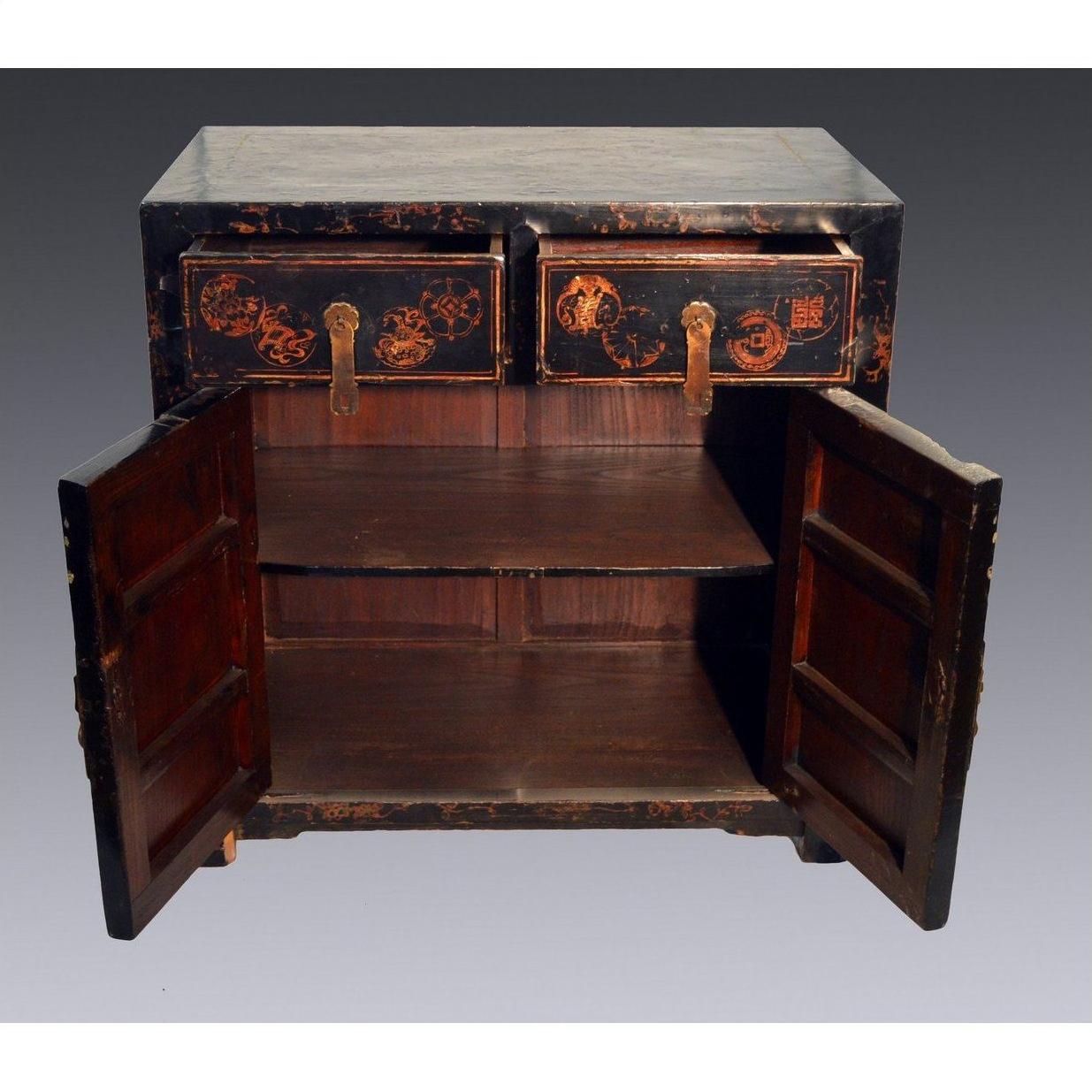 Black antique Chinese Chinoiserie wood cabinet with scalloped hardware, two top drawers, and double doors over empty shelf.