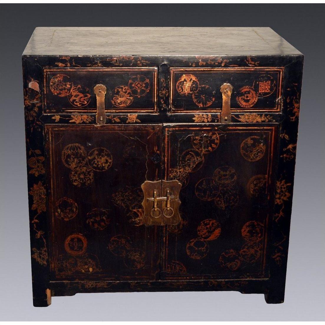 Black lacquered wood Chinese Chinoiserie cabinet with gold accents, red floral patterns, two drawers, scalloped hardware.