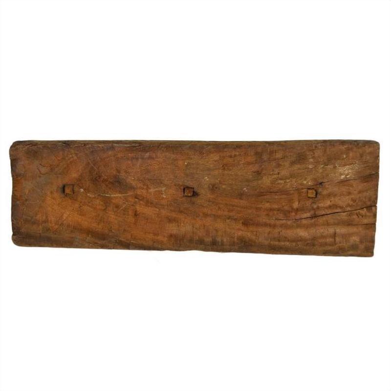 Brown weathered wood plank with three square holes, rustic finish, antique Indian carving.