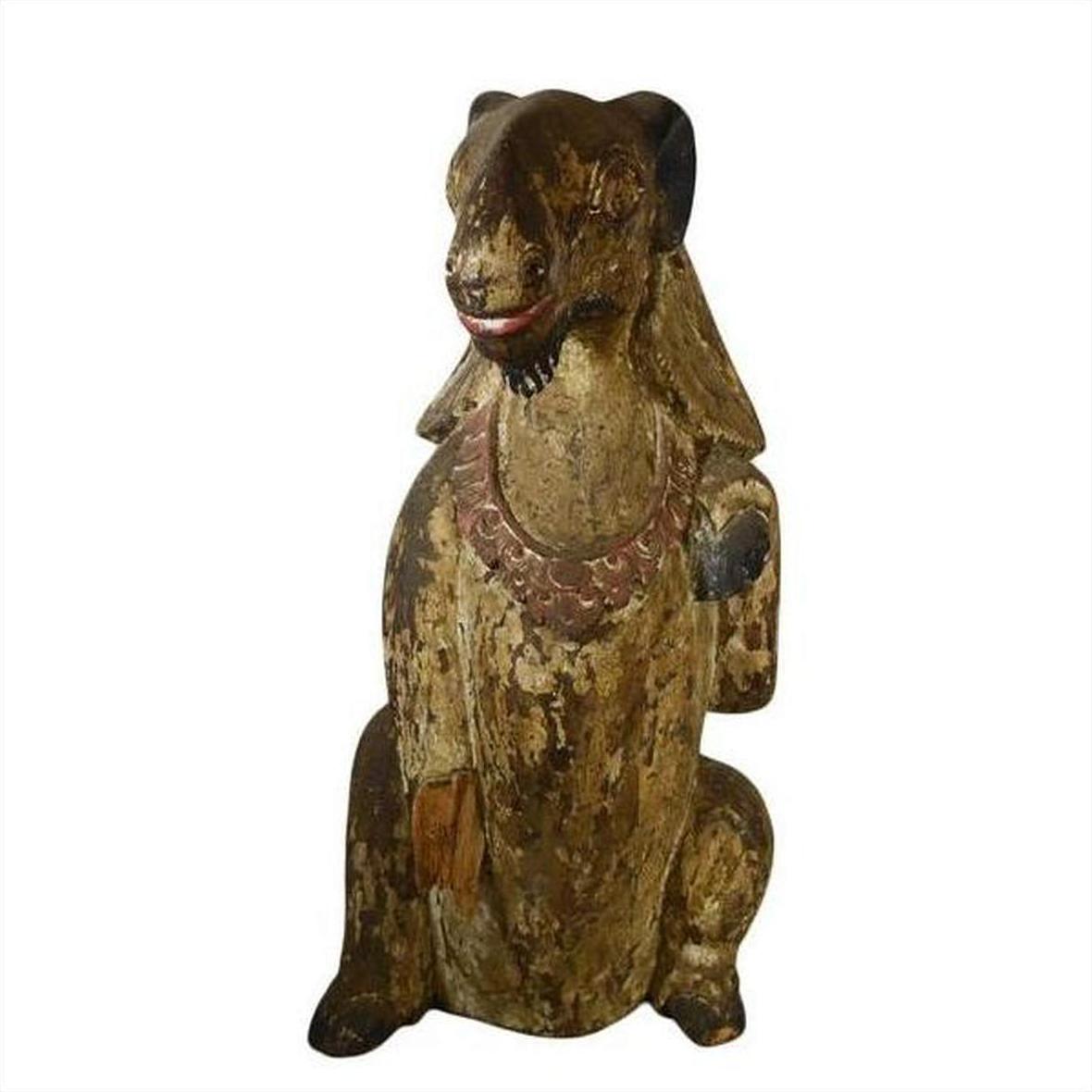 Brown hand-carved wood seated goat sculpture with necklace, 19th century Burmese, close-up view.