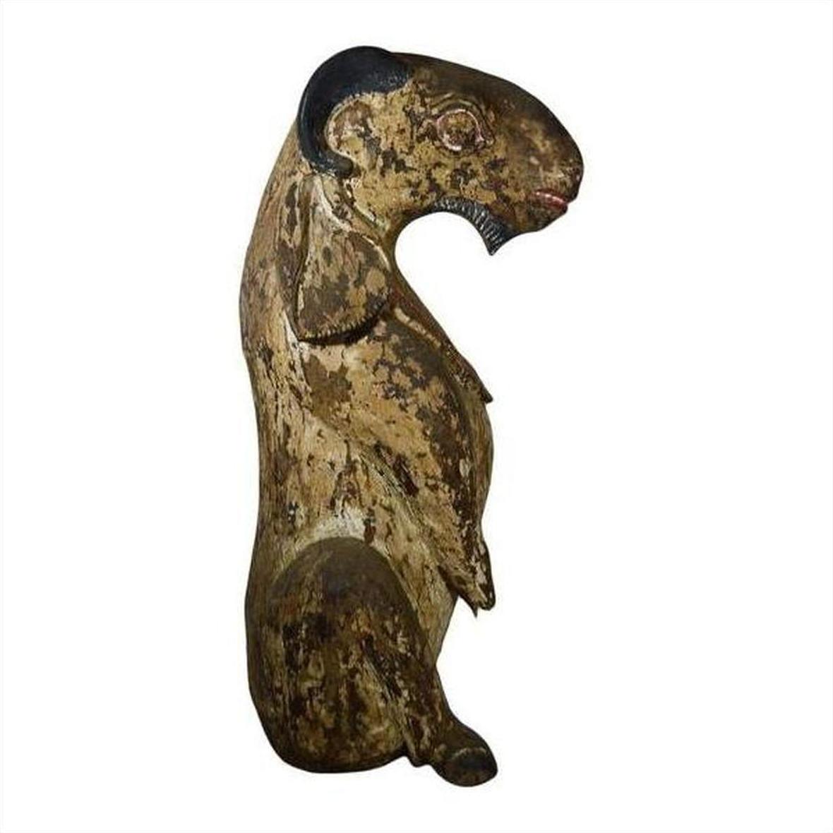 Brown wood seated goat sculpture with horns and faded paint, hand-carved, 19th-century Burmese style.