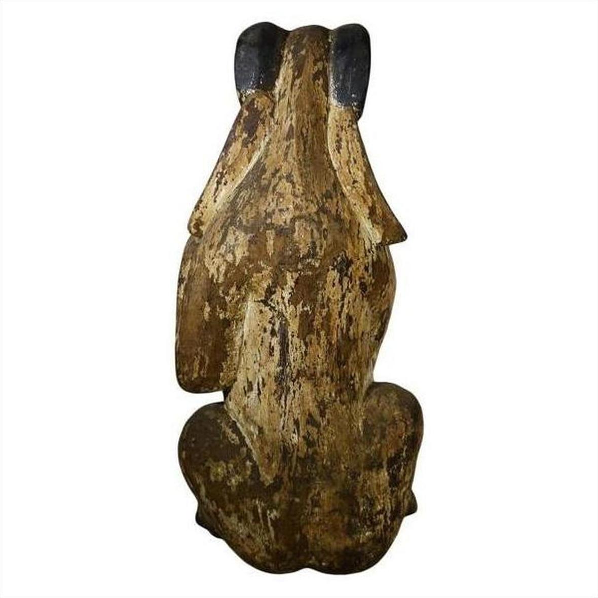 Brown wood seated goat sculpture with rustic finish and dark-tipped ears, hand-carved, 19th century Burmese style.