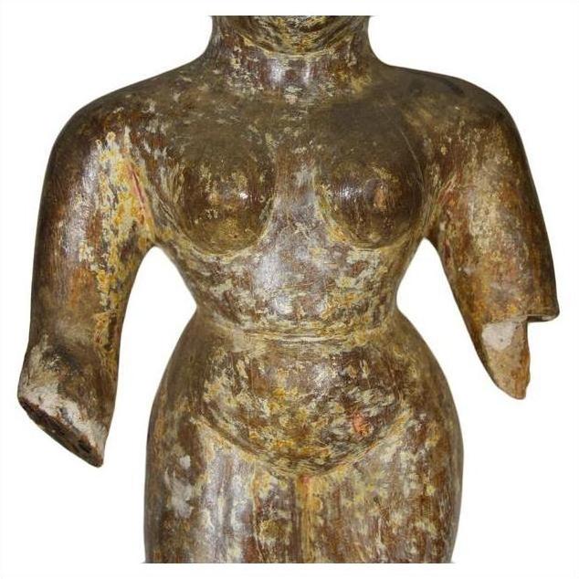 Bronze armless torso temple carving, weathered and textured, antique Burmese art, close-up view.