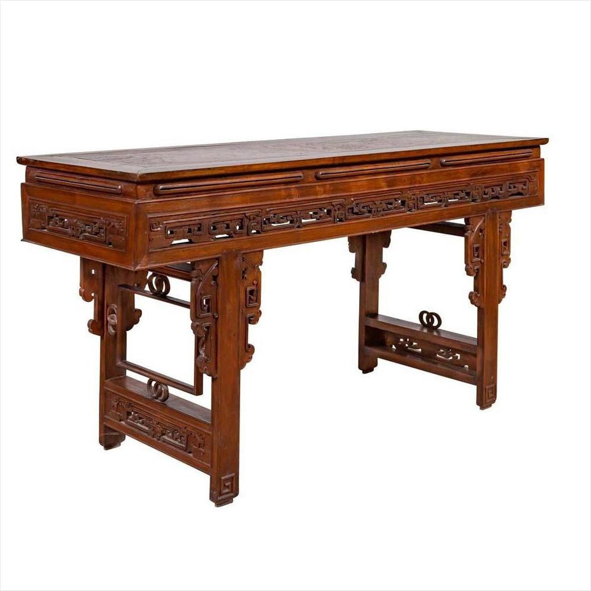 Dark wood Chinese altar console table with overhang top and carved open fretwork scroll detailing, studio view.