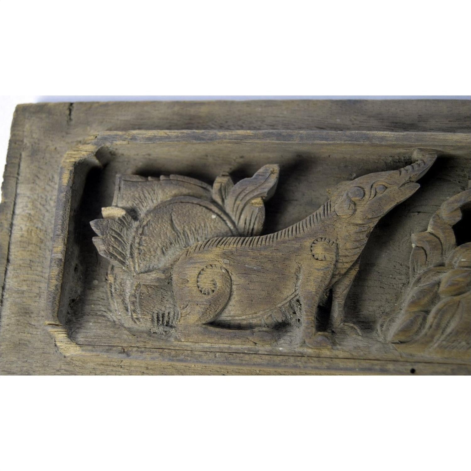 Brown carved wood temple plaque with dog or wolf relief and ornate patterns, 12x4x1 inches, good condition.