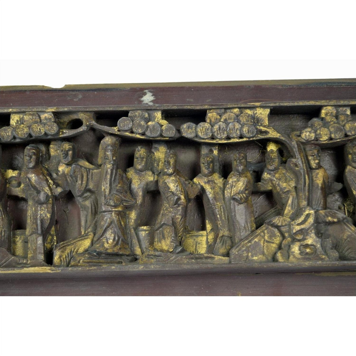 Close-up of antique Chinese wooden temple plaque with gold accents, robed figures, and rounded tree foliage.