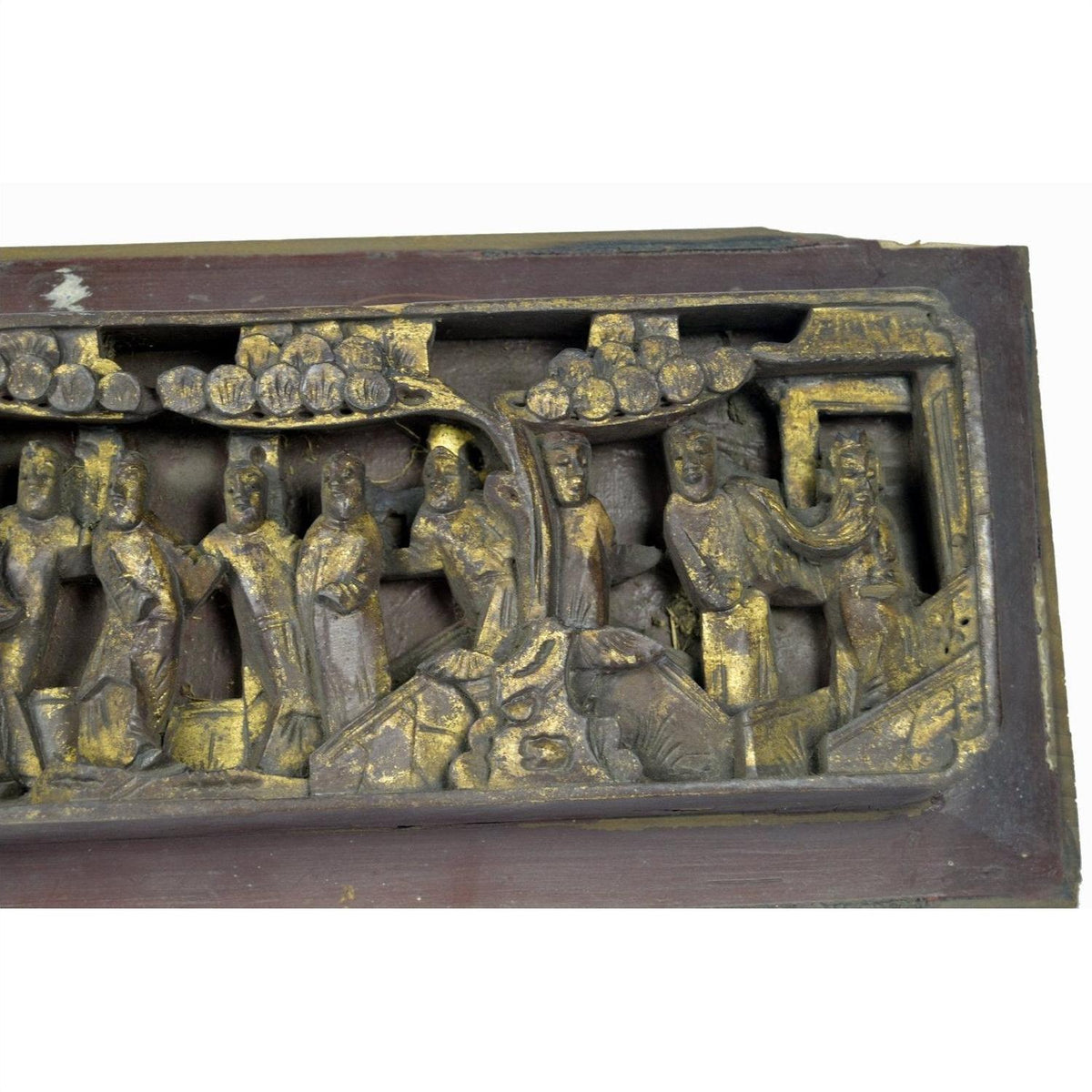 Gold-painted wood Chinese temple plaque with carved figures and trees, detailed wall art, close-up view.