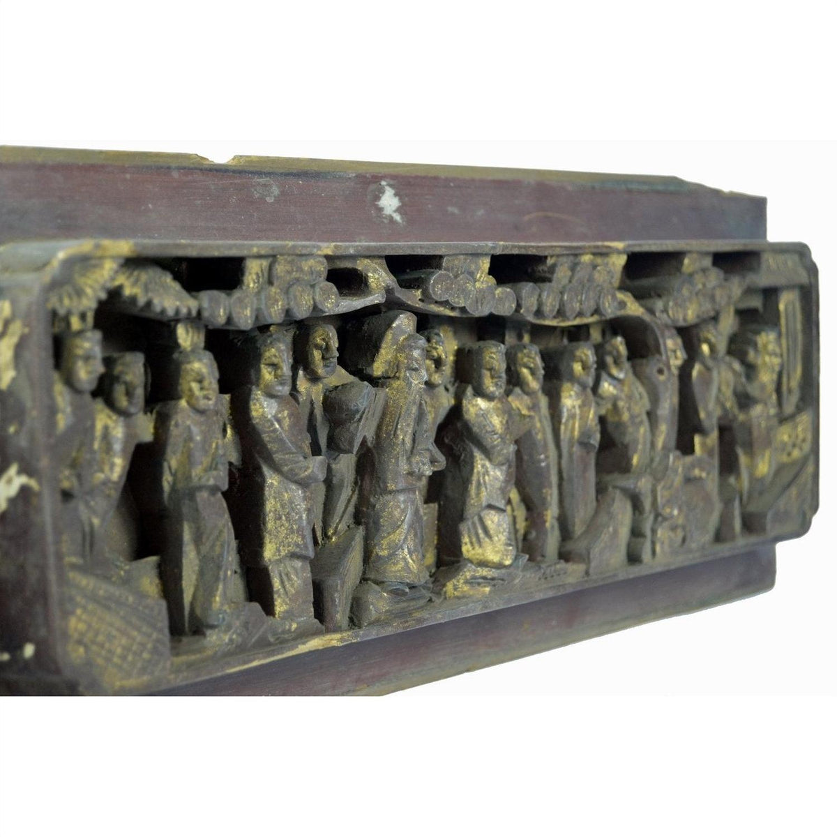 Wooden and gold antique Chinese temple plaque with carved figures in traditional dress beneath trees, angled view.