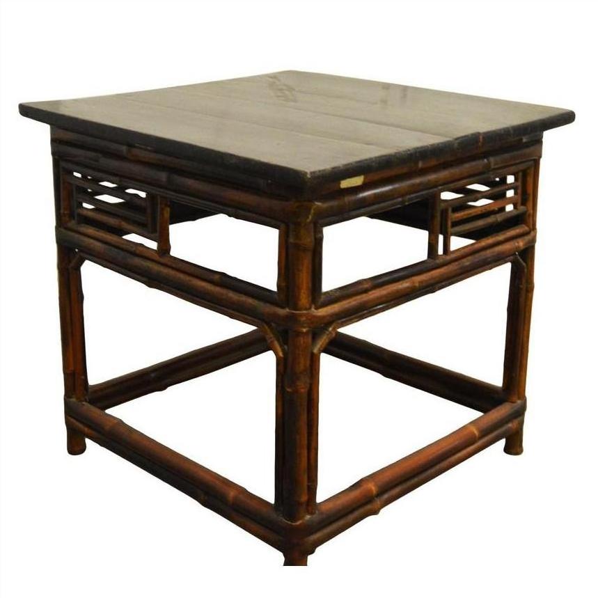 Brown bamboo side table with flat wood top, decorative frame legs, and lacquered finish, antique style.