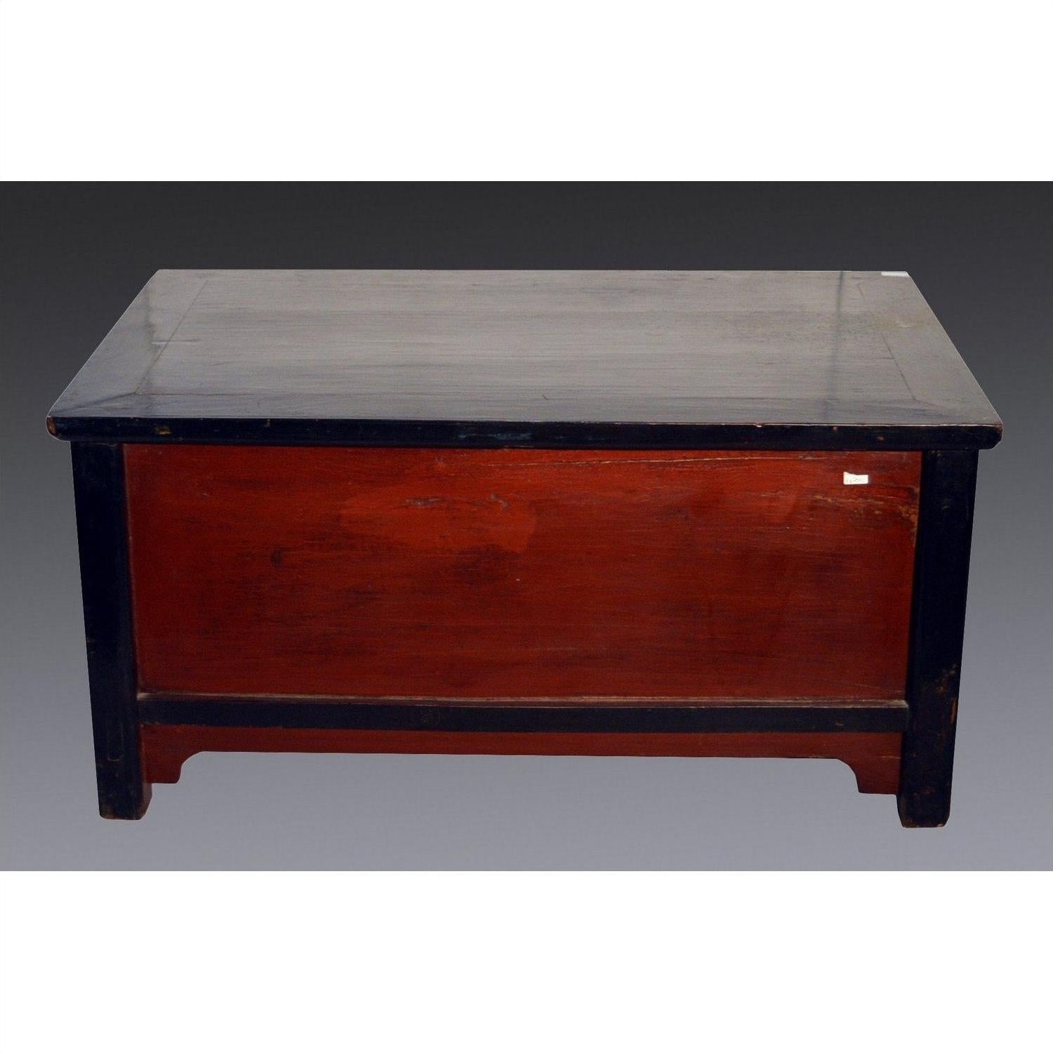 Black lacquer antique Chinese cabinet with dark brown top, legs, and reddish-brown front panel, on gray background.