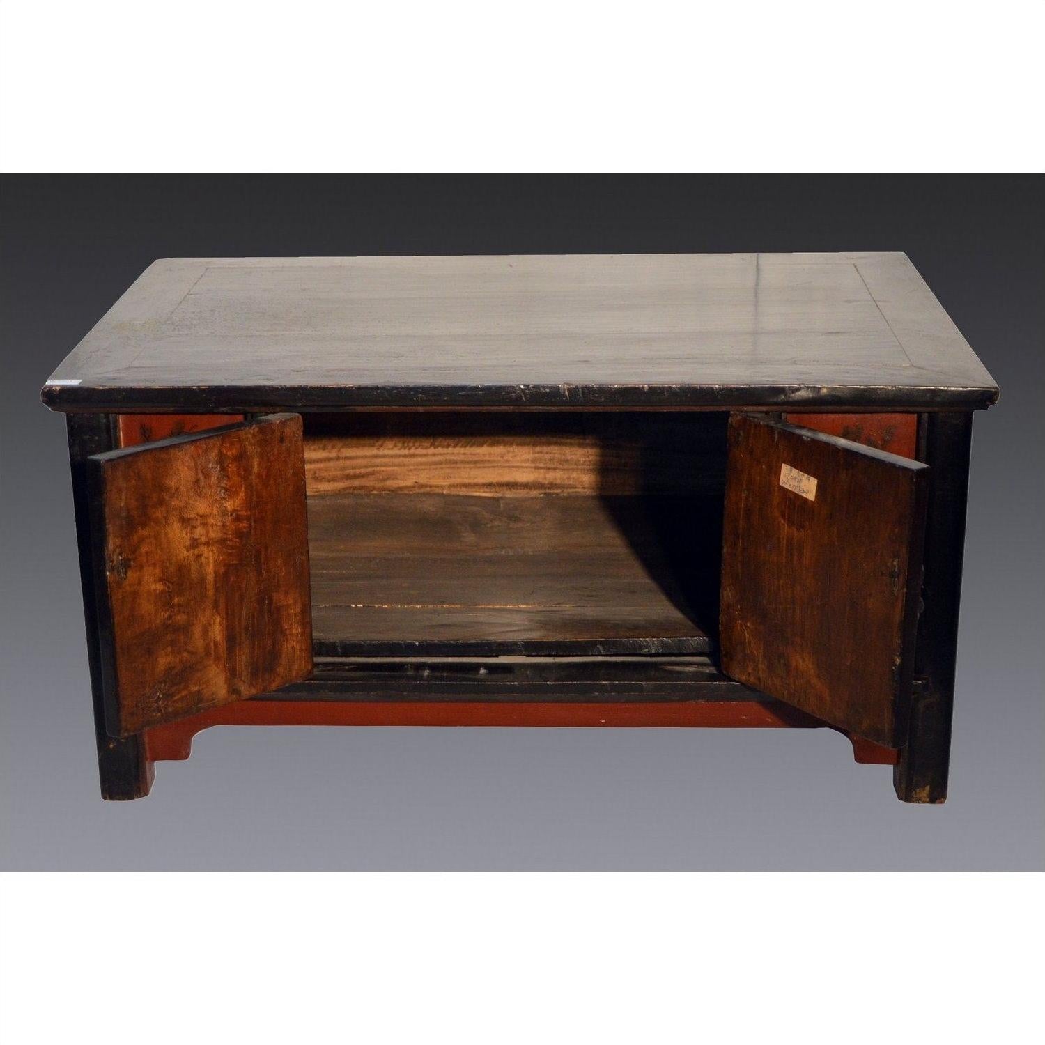Black lacquer antique Chinese cabinet open with empty shelf, shown against a plain background.