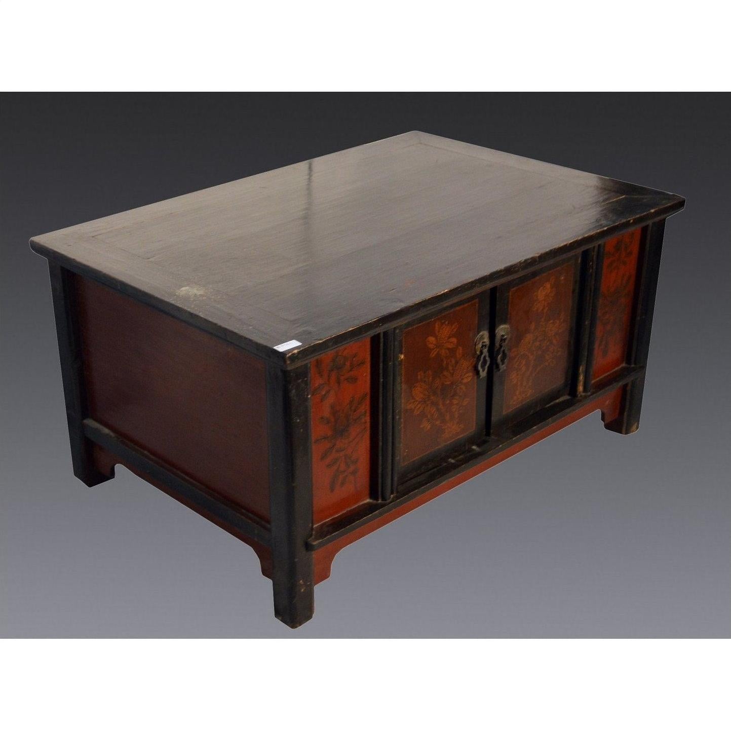 Black lacquer antique Chinese cabinet with floral front panels and short legs, set against a gray background.