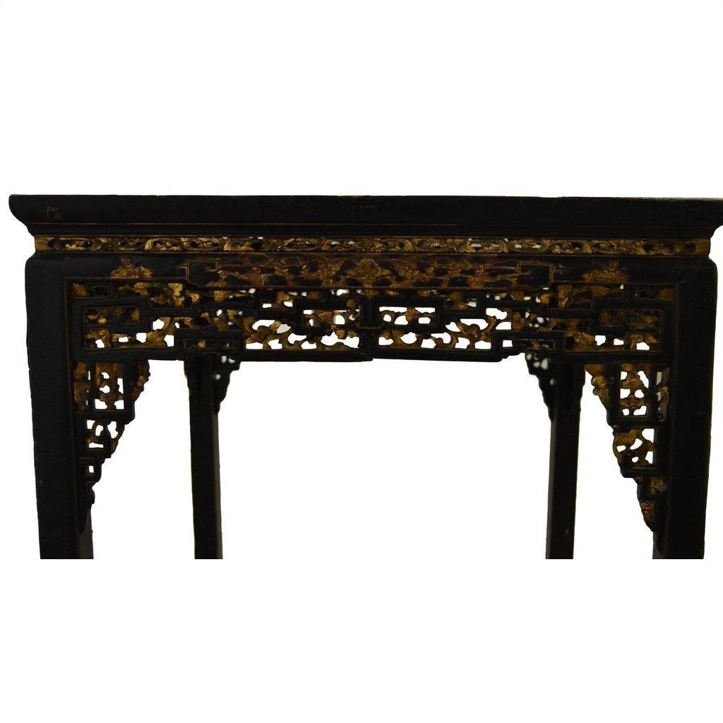 Black lacquer wood altar table with gold and red carved detailing, shown against a white background.