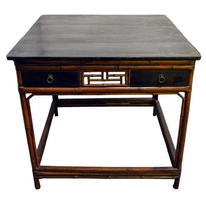 Black lacquered wood Chinese table with two drawers, bamboo-style legs, and central openwork panel, front view.