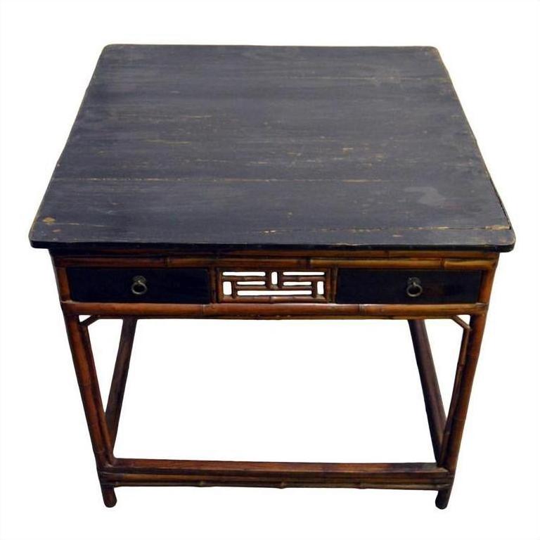 Black lacquered square Chinese table with two drawers, bamboo-style legs, and decorative cut-out front detailing.