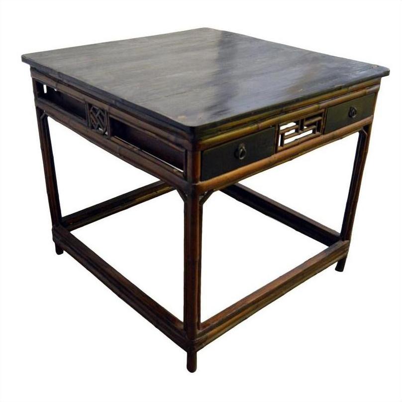 Black lacquered antique Chinese table with decorative side panels and two small drawers, front view.