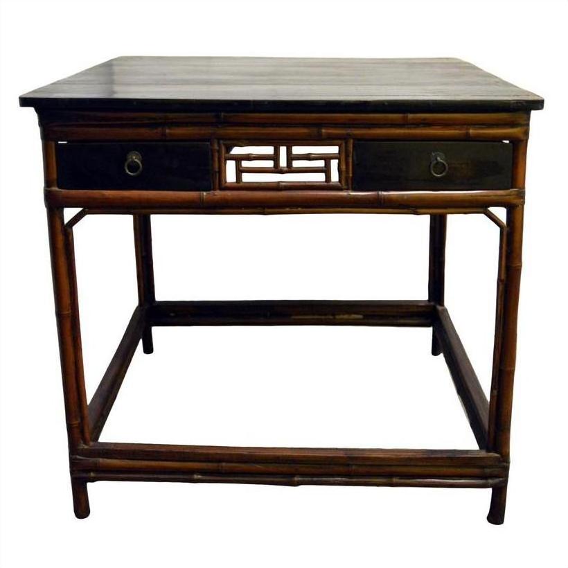 Black lacquered wood Chinese table with bamboo-style legs and two drawers, front view.
