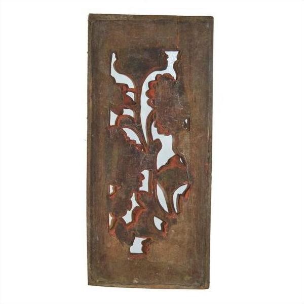 Brown wood rectangular panel with carved floral pattern, cutouts, and weathered vintage finish, close-up view.