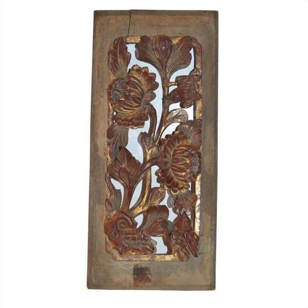 Brown wooden panel with intricate floral carvings, antique Chinese style, rustic and weathered, close-up view.