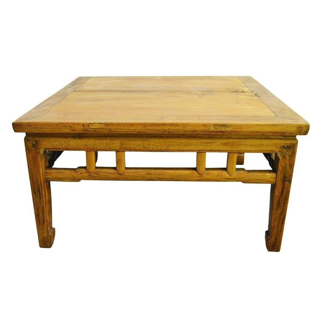 Light brown wood antique Chinese coffee table with rectangular shape and sturdy legs, isolated on white background.